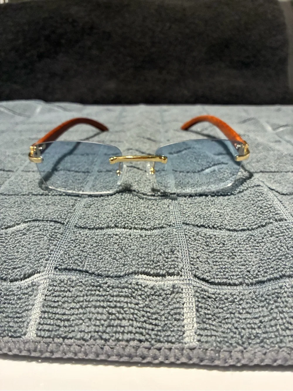 Rimless Blue Lens Sunglasses with Wood Arms and Gold Bridge